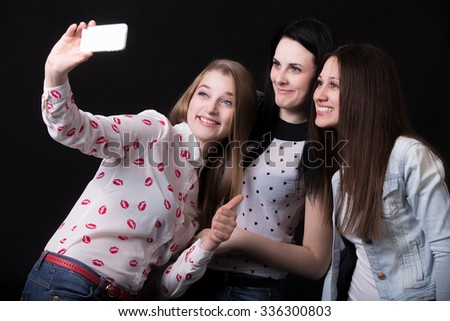 Group of beautiful girlfriends laughing, taking selfie, self-portrait with mobile phone, best friends happy smiling together, having fun, posing for group photo