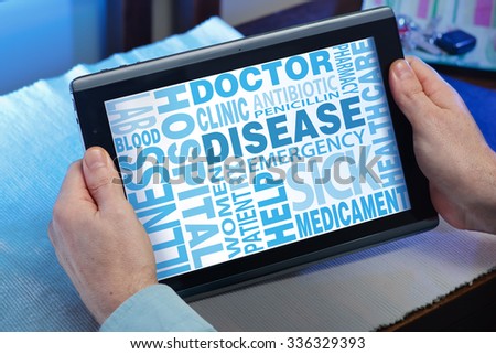 man looking with tablet a screen with message text graphics and tags word clouds concept related sickness / hands of a man looking words cloud related disease in the tablet
