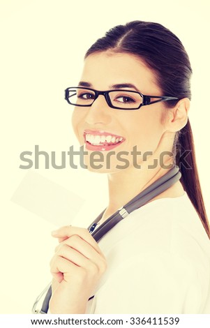 Young female doctor holding business card