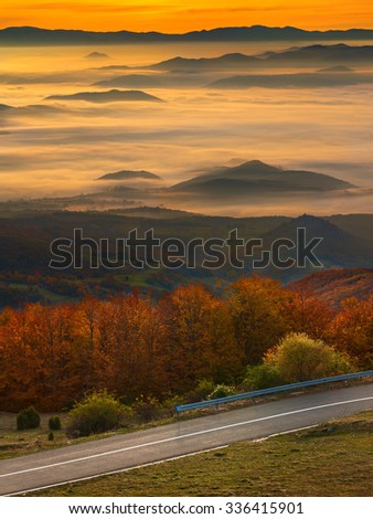 Empty road in idyllic mountain scenery at autumn ambiance illuminated by morning sunlight. Mountain Golija, Serbia.