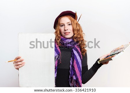 studio shot of redhead woman painter on white background