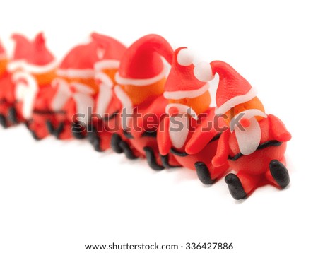 Row of clay Santas isolated on white background