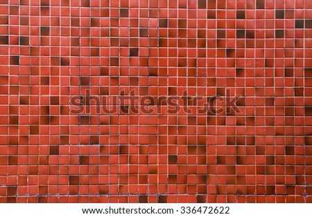 square pattern on red tile wall