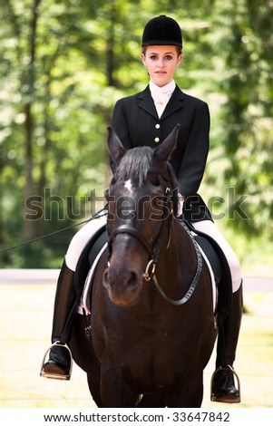 A caucasian girl riding a horse outdoor