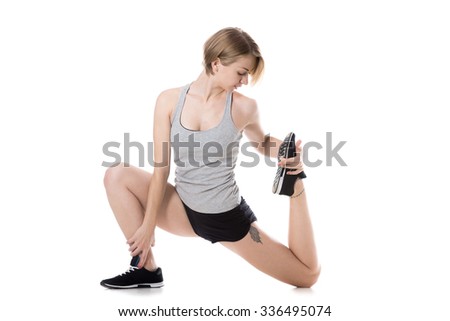 Young slim beautiful woman warming up before working out, doing low lunges, stretching exercises for legs and hips, full length isolated studio image on white background