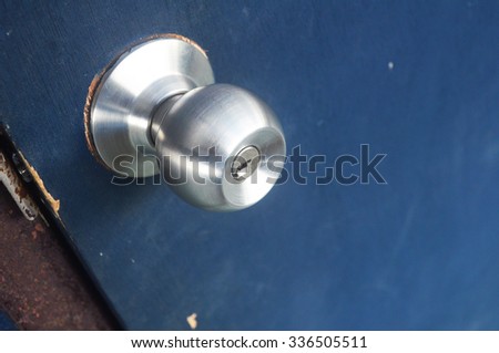Door knob with dark blue door.