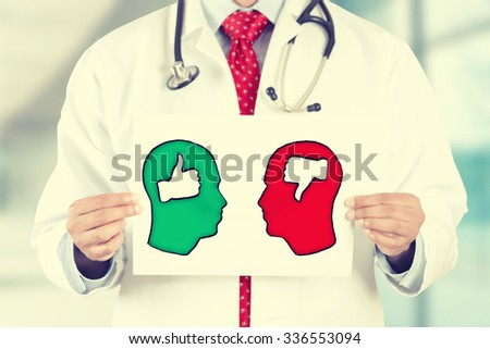 Closeup doctor hands holding white card with green red thumbs up thumbs down symbols inside signs shaped as human head isolated on hospital clinic office background. Retro instagram style filter image