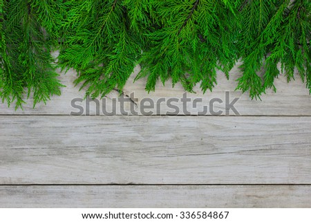 Green Christmas tree garland border on antique rustic wood background