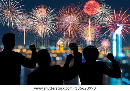 The people looks Fantastic festive new years colorful fireworks on cityscape blurred photo bokeh,project success, holiday concept, family concept