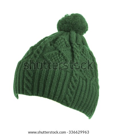  green knitted hat with pompom isolated on white background .
