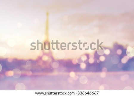 Blurry Christmas background. Eiffel Tower and bokeh lights. Vintage (retro) effect.