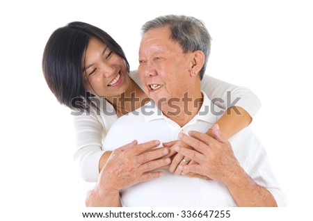 Senior man and daughter. Happy Asian family senior father and adult offspring having fun time at indoor studio. Royalty-Free Stock Photo #336647255