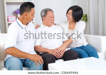 Asian senior father with his adult son and daughter at home. Family living lifestyle. Royalty-Free Stock Photo #336649466