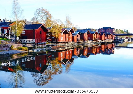 Classic old wood houses and their reflection in river, Porvoo Finland Royalty-Free Stock Photo #336673559