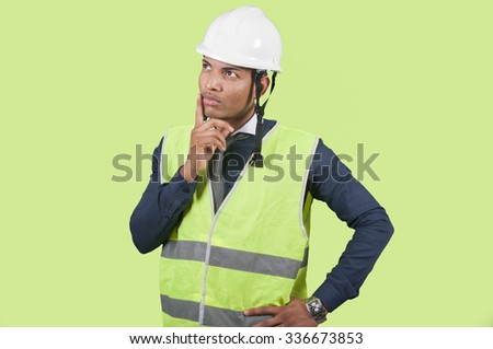 Worker thinking on green background
