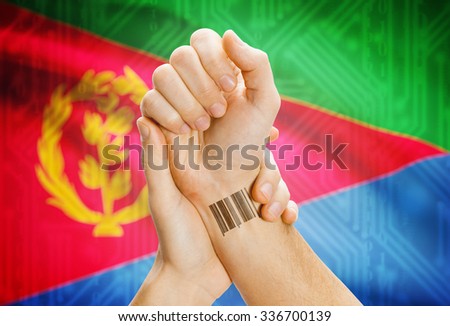 Barcode ID number on wrist of a human and national flag on background - Eritrea