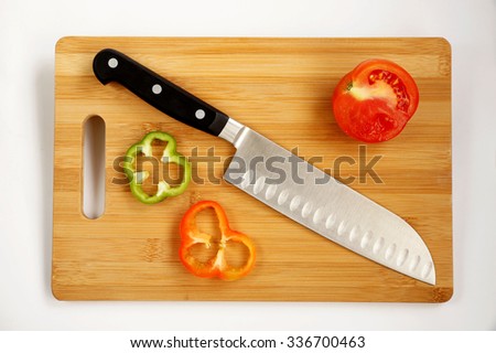 Knife cook universal with a blade like Santoku on a chopping board Royalty-Free Stock Photo #336700463
