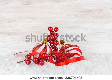 Christmas balls and snowflake on wooden background