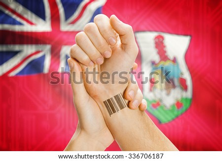 Barcode ID number on wrist of a human and national flag on background - Bermuda