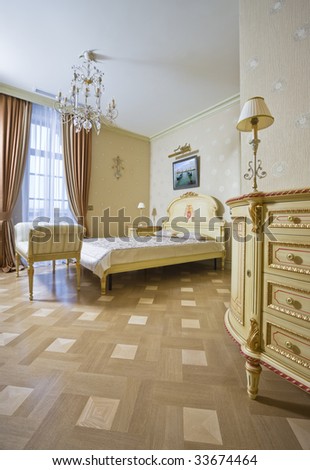 Beautiful bedroom with a dresser and a parquet floor