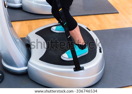 Woman plates in gym doing fitness exercise Royalty-Free Stock Photo #336746534