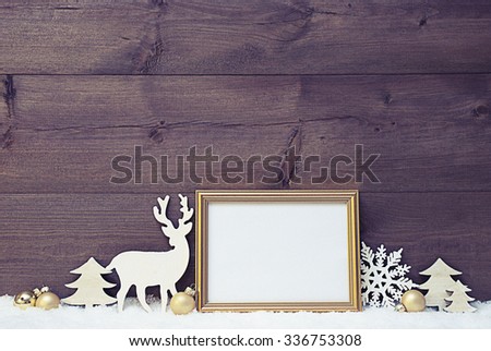 Vintage Christmas Card With Picture Frame On White Snow. Copy Space For Advertisement. White Christmas Decoration Like Snowflake, Tree, Golden Balls And Reindeer. Shabby Chic Wooden Background.