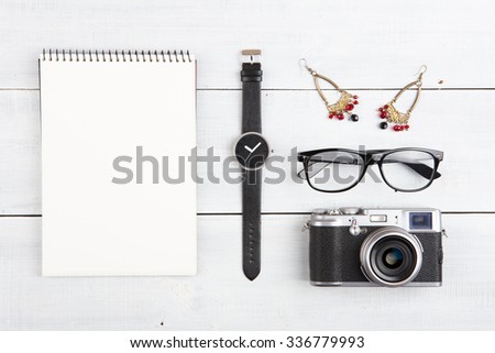 woman travel concept - set of camera, notepad, watch etc
