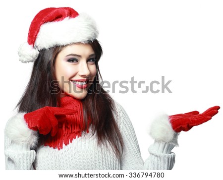 Beautiful smiling christmas santa woman pointing up showing copyspace. Isolated on white background.