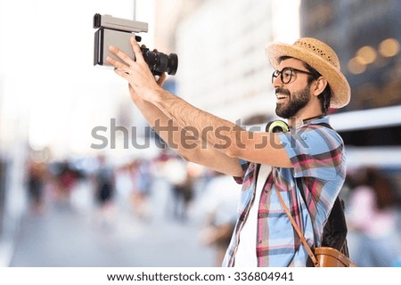Tourist filming on unfocused background