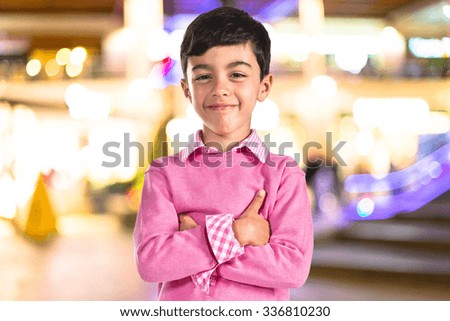 Brunette kid with his arms crossed 