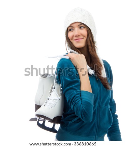 Young woman holding ice skates for winter ice skating sport activity in white hat smiling looking at the corner  isolated on a white background