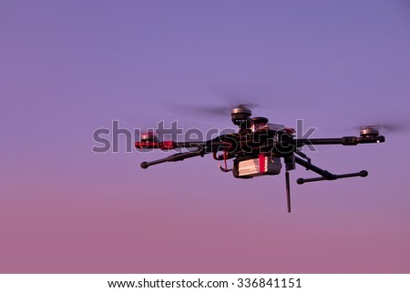 Drone hovering in a colorful sunset. Soft focus. Toned image