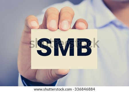SMB letters (or Small and Medium-sized Businesses) on the card shown by a man