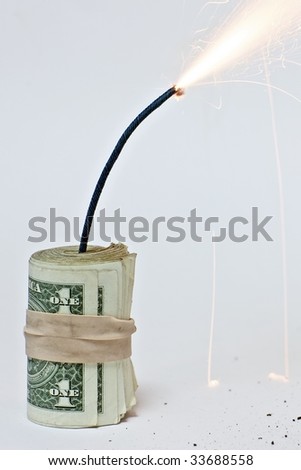 Roll of dollars attached to a burning fuse on a white background. Royalty-Free Stock Photo #33688558