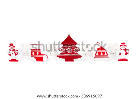 Wooden Christmas figurines snowmen snowflakes Christmas tree hat and stocking isolated on a white background.