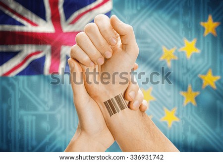Barcode ID number on wrist of a human and national flag on background - Tuvalu