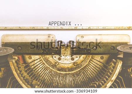 Vintage typewriter and a empty white paper with a word Appendix , process in vintage style