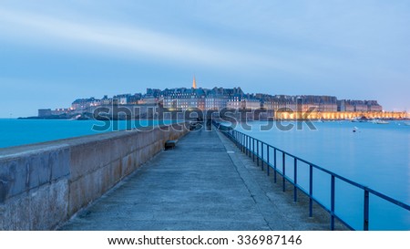 St Malo, Panorama Seaside View over the walled city Saint-Malo medieval pirate fortress and St Vincent Cathedral at Night in Summer under Blue Sky Blur Cloud, Brittany, France from lighthouse