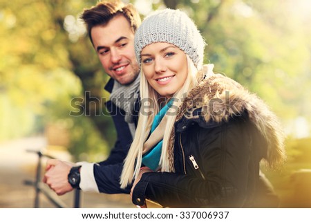 A picture of a young romantic couple in the park in autumn