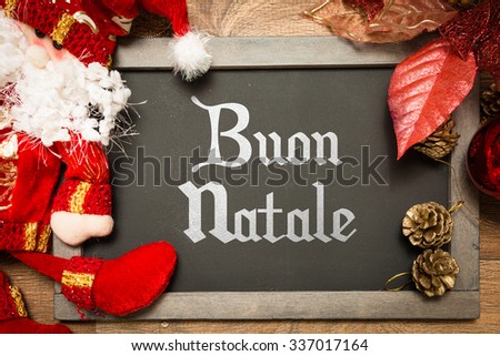 Blackboard with the text: Happy Christmas (in Italian) in a conceptual image