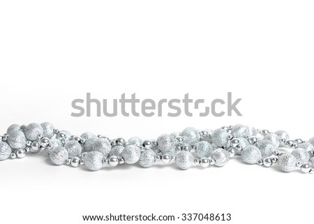 2016 year blue silver ornaments beaded necklace for Christmas tree on the background of silvery and blue Christmas decorations. Merry Christmas balls and pine tree branches
