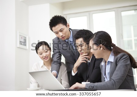 Group of businesspeople discussing,working on computer