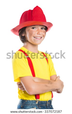 Closeup of smiling boy wearing firefighter helmet isolated on white background. Happy little fireman looking at camera with armcrossed.
