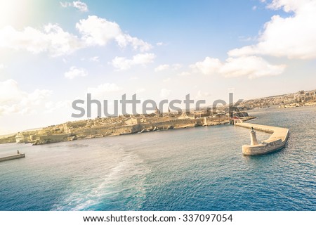 Tilted horizon view of La Valletta before sunset from the sea - Travel and wanderlust concept with capital of world famous mediterranean island of Malta - Wide angle composition with cruise ship track