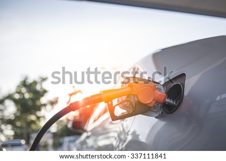 Car refueling on a petrol station. Royalty-Free Stock Photo #337111841
