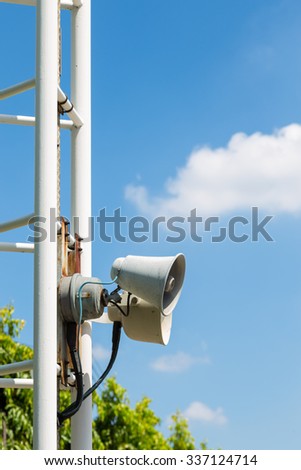 mini loud speaker on pole with blue sky