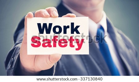 Work Safety word on the card held by a man hand, vintage tone