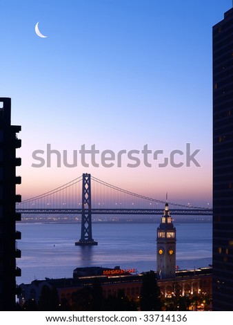 The moon will fall down to the horizon. Ferry Building & Bay Bridge enveloped in beautiful sky looked so mysterious.