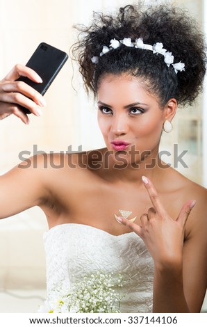 Closeup portrait of beautiful exotic emotional bride taking a selfie
