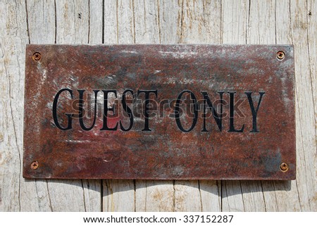 mental guest only signage on white wooden wall